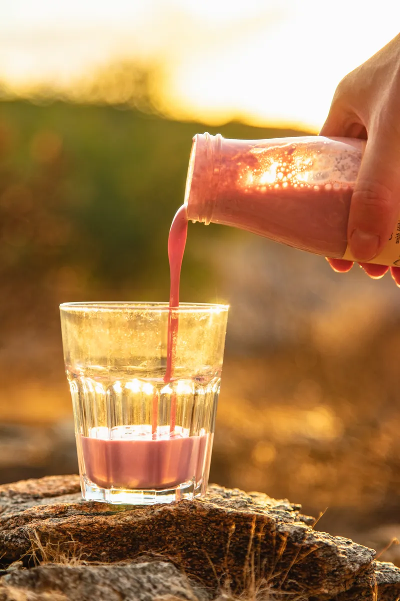 Pouring Butta into a glass at sunset