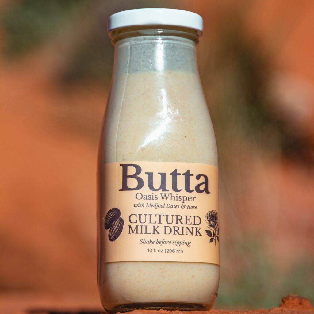 Butta Oasis Whisper cultured milk drink with dates, cinnamon and rose in desert light